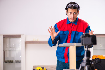 Young contractor recording video for his blog