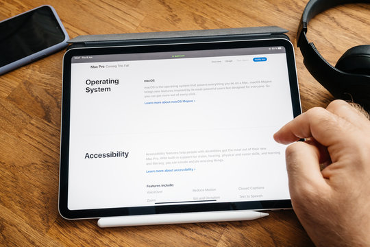 Paris, France - Jun 6, 2019: Man Reading On Apple IPad Pro Tablet About Latest Announcement Of At Developers Conference WWDC - Showing The Mac Pro Workstation With Operating System And Accessibility