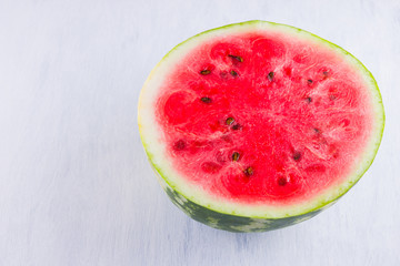 Half of watermelon on white background. Sliced watermelon on light background. Healthy food for vegan. Top view