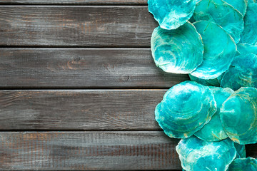 Seaside pattern with shells on wooden background top view space for text