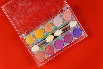 Colorful makeup palette, eye shadow in clear box.