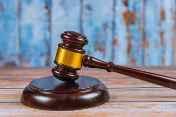 Wooden judge gavel isolated on wooden background.