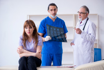 Two doctors examining young woman