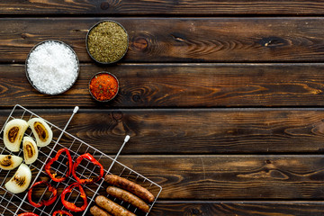 barbecue, sausages, vegetables on wooden background top view space for text