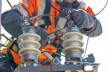 Working electrician works with electrical equipment