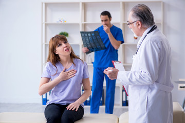 Two doctors examining young woman