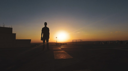 Fototapeta na wymiar Man photographer silhouette at sunset