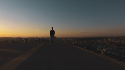 Fototapeta na wymiar Man photographer silhouette at sunset