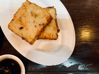 radish cake, turnip cake, daikon cake, serve on wooden table with Black Vinegar sauce