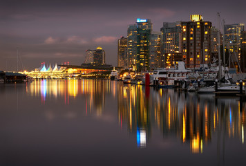 Coal Harbour Twilight Lights. The Vancouver skyline reflects in Coal Harbour at night. British Columbia, Canada.