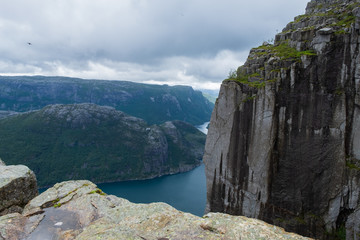 Preikestolen massive cliff (Norway, Lysefjorden summer morning view). Beautiful natural vacation hiking walking travel to nature destinations concept. July 2019