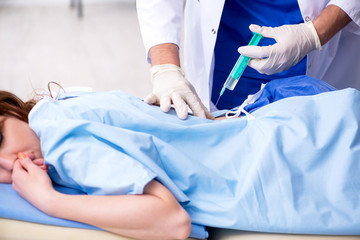 Female patient getting an injection in the clinic