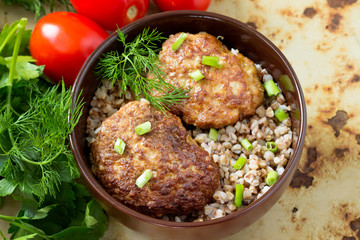 Homemade meatballs with buckwheat in a bowl.