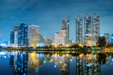 Obraz na płótnie Canvas Bangkok city night skyline view in the business district with lake water reflection , Bangkok , Thailand