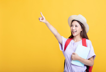 Young asian girl  student holding the  book  and pointing