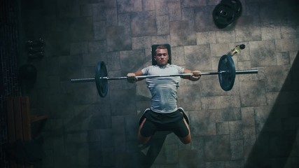 Top View of Professional Athlete Doing Bench Press Workout with a Barbell in the Hardcore Gym. Muscular and Athletic Bodybuilder Doing Barbell Exercise. Zoom Out - Powered by Adobe