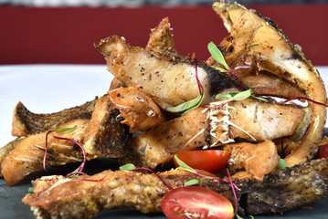 fried fish strips served on stone