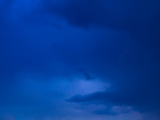 Obraz premium Samall lightning in the dramatic storm clouds - long exposure