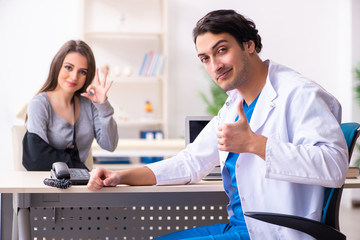 Fototapeta premium Young male doctor and female beautiful patient