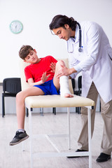 Leg injured boy visiting young doctor traumatologist