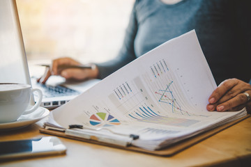 Business man working with document financial in open space office. Meeting report in progress.