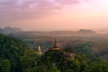 Fotobehang Lanscape of two pagodas on top mountain at Dharma Khao Na Nai Luang Park  Surat Thani, Thailand. © amornchaijj