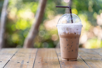 Ice cappuccino or latte coffee on wooden table.