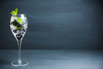 Billberry mojito cocktail in wine glass. Selective focus. Shallow depth of field.