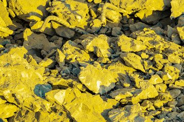 Yellow and gray pieces of construction debris. Front view from above.