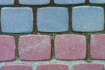 Two-tone concrete tile on the sidewalk in the city. View from above.