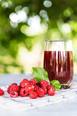 Fresh raspberries juice with bokeh background.