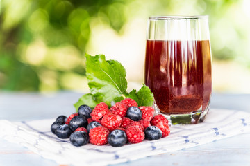 Fresh mixing for blueberry and raspberries juice with bokeh background.