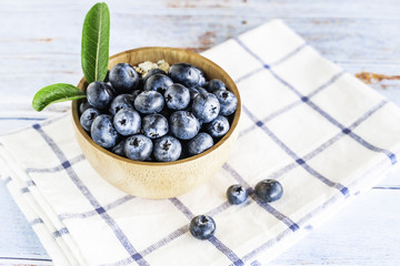 Fresh blueberries in wooden background.