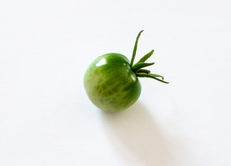 small green cherry tomato on white background