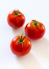 small red cherry tomatoes on white background
