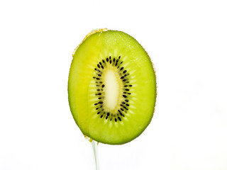 photo slice of kiwi fruit in juice on a white background
