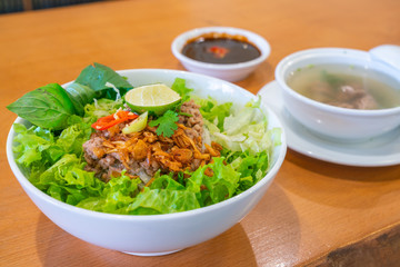 Delicious and colorful bowl of traditional Vietnamese pork noodle soup