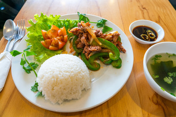 Stir fried beef slices served with vegetables and rice