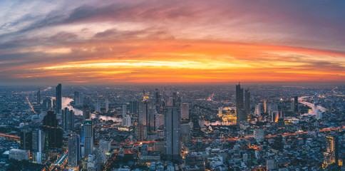 Fototapeta na wymiar Panorama of Bangkok city river curved skyline with sunset light.