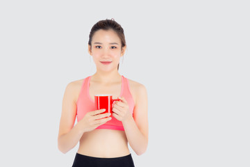 Beautiful young asian woman in sport after workout drinking water from glass for thirsty isolated on white background, girl after exercise drink coffee or tea for hydration and refresh with healthy.