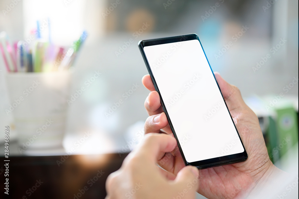 Poster man using smartphone with blank screen for graphics display.