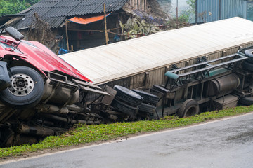 Accident on mountainous road, motor vehicle accident, car wreck. Long vehicle overturned and lying...