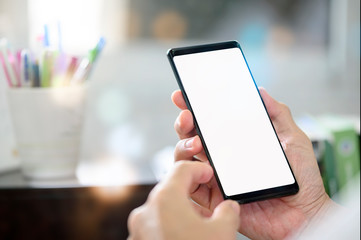 man using smartphone with blank screen for graphics display.