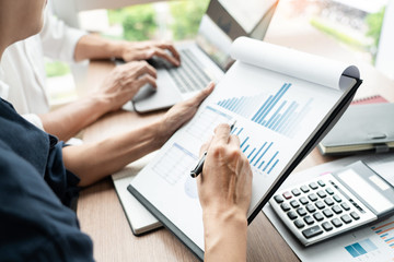 Teamwork concept, Business executives discussing document work at meeting in modern office lobby.