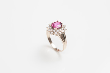 Ring of the jewelry with pink sapphire isolated on white background