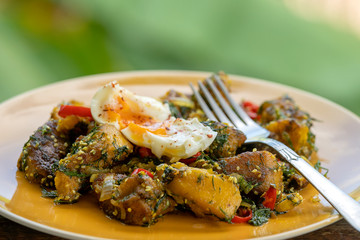 Fried pumpkin with spices together soft-boiled egg