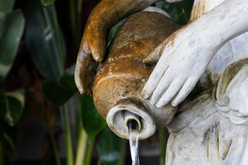 Old statue in the garden background