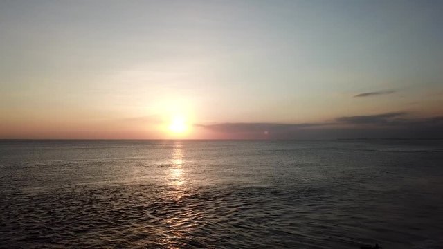 Legian Beach, Bali / Indonesia - July 2018: Surfers enjoying the waves off Legian Beach, Bali at sunset