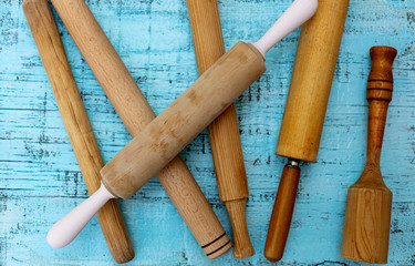 Vintage old kitchen utensils on a blue wooden background.