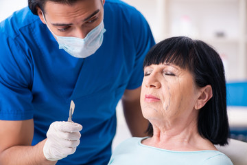 Old woman visiting male doctor for plastic surgery